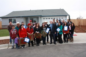 USDA California Rural Development Single Family Housing Program Director Ron  Tackett joins 11 families in front of one of the homes they jointly built in Reedley.