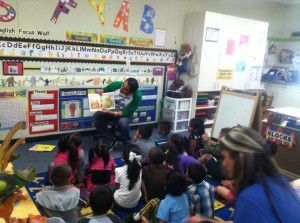 Robert Isquierdo shares the joy of reading with a class of young students.