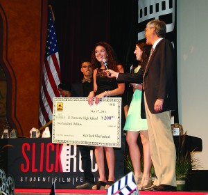 El Diamante High School’s Courtney Berk (left) and Randi Sumpter receive a check from Tulare County Supervisor Allen Ishida for their film “Take a Walk.” 