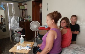 Sissy Morton and her grandchildren trying to complete her home dialysis in a sanitary environment with no water.