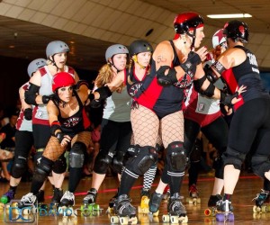The V Town Dames battle to beat Sacramento’s Sacred City Derby Girls. The V Town Dames (in red and black), include Jessica Loya, Amber Clark, Chrissy Buma and Melissa Hawkins. Photo by David Costa.