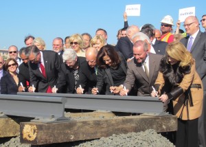 Instead of the traditional shovels in the ground, Governor Jerry Brown, Fresno Mayor Ashley Swearengin, Gina McCarthy, head of the Environmental Protection Agency, and about 40 other dignitaries signed a ceremonial piece of steel rail that will be on display at the Sacramento Railroad Museum.