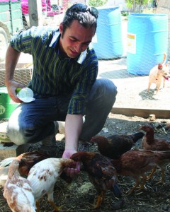 Danny Ochoa Leon, one of the main forces behind Sustainable Communities Project Tulare, feeds a flock of juvenile chickens at his home in rural Tulare. SCP Tulare is a group of volunteers working to build a stronger sense of community and foster cooperation between neighbors. Photo by: Dave Adalian