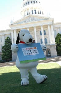 Snoopy shows off new license plate design.