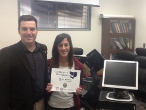 Superviser Pete Vander Poel presents a computer to Alexis Manson.