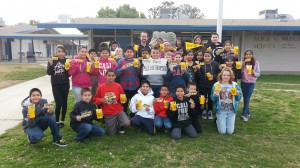 Members of Matthew Johnson’s sixth-grade class show off Southern Miss memorabilia outside their school in Tulare. 