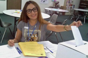 SEIU union employee casting her vote on the employee contract negotiated in July.