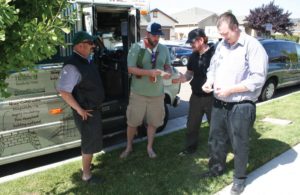 Hemp Road Tour organizer Rick Trojan, center, hands out information on industrial hemp to Cameron Chipchase and Doug Stark during a stop in Visalia. Chipchase, a Navy veteran who was injured during his service, and Stark have formulated a spray using CBD produced from hemp raised by Trojan’s company. The pain-relieving spray is available in Visalia at Sensations or by calling Hemp Sciences at (559) 799-9879. All the clothing Trojan is wearing is made from hemp. Dave Adalian/Valley Voice