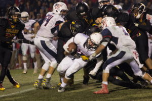 Tulare Union's Tribe takes down Mustang running back Mason Bernardo in the 4th quarter of the Bell Game. The Tribe won the game 48-27. Daniel Nunez/Valley Voice